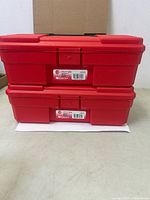 Two stacked red Akro-Mils utility boxes, closed view