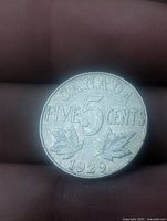 Reverse side of 1929 Canadian 5-cent coin showing denomination and date