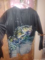 Back view of black long sleeve shirt showing large bass fish graphic and water splash