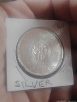 Reverse of 1964 Canadian Charlottetown Quebec silver dollar in 2x2 holder