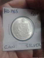 Reverse of 1965 Canadian 50-cent coin showing coat of arms