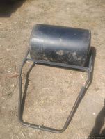 Angled view of lawn roller showing poly barrel and metal frame