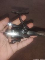 spinning reel front and side view in hand