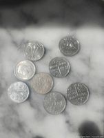 group of 8 Canadian nickels showing obverse and reverse designs