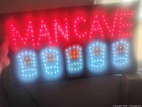Sign powered on showing full MAN CAVE text and four beer mug icons lit