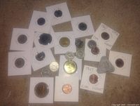 Overhead view of all coins in 2×2 holders, assorted denominations visible