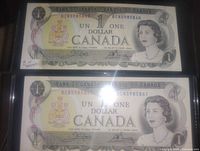 Obverse of both 1973 $1 notes showing Queen Elizabeth II and sequential serial numbers