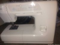 left side view of white sewing machine showing stitch selection panel