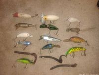 Group shot of all fishing lures and straps laid on carpet