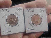Front view of both 1973 RCMP quarters in 2×2 holders