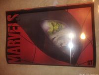 Front cover showing red Spider-Man mask design and vertical MARVELS logo