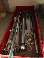 Red drawer with assorted wrenches, ratchet, sockets