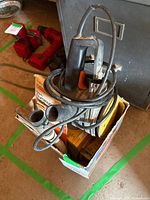 Sander, vacuum tubes and disc boxes in cardboard box