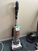 Full view of Electrolux upright vacuum standing against wall