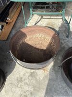 Interior and exterior view of first cast iron cauldron showing rust and drain holes