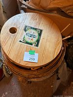 Round wooden lid on top of straw-wrapped barrel