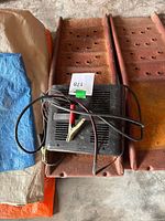 Charger with cables and clamps visible