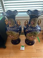 Pair of matching cobalt blue floor vases standing side by side