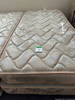 Top view of twin mattress on box spring showing quilted floral surface