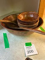 Large salad bowl, stack of small bowls, utensils