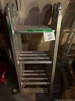 Folded Werner articulating ladder standing vertically