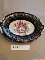 Top view showing cobalt blue and gold rim and floral center