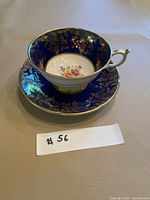 Teacup on saucer showing cobalt blue and gold design