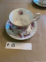 Teacup on saucer top view showing interior floral motif and gilt rim