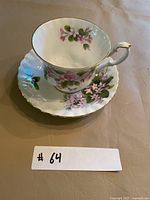 Teacup on saucer showing floral pattern and gold trim