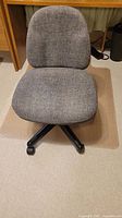Front view of grey upholstered swivel chair