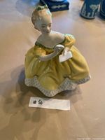 Front view of Royal Doulton figurine in yellow dress