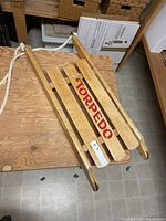 Top view showing TORPEDO logo across three slats and rope handle