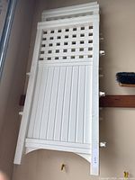 Full view of one white Suncast plastic fence panel hanging vertically