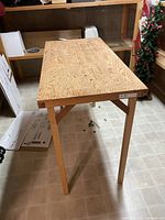 Full view of rectangular wood work table top and legs