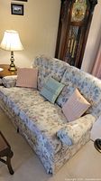Front view of floral upholstered couch with pillows