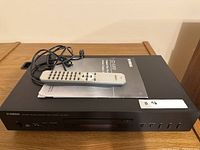 Top view of Yamaha CD-S300 with remote, manual, power cord