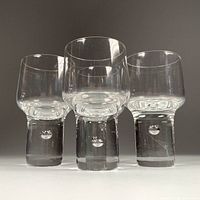 Front view of four Kosta Boda Mambo shot glasses showing bases with controlled bubbles