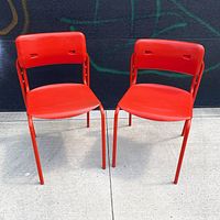 Front view showing both red Folke chairs side by side