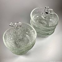 Stacked view of six clear textured glass apple bowls