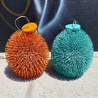 Front view of both pendant lights showing colors and spiky design