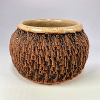 angled view showing bark-textured exterior of stoneware bowl