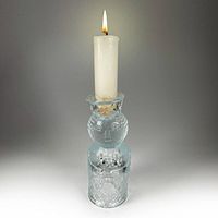Candle holder upright with taper candle inserted showing overall design