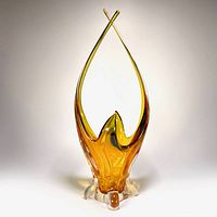 Front view of amber freeform art glass pedestal basket vase