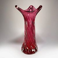 Full front view of rose pink twisted art glass vase