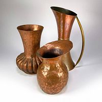 Group shot of three hammered copper vessels