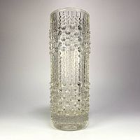 Front view of clear pressed glass vase showing candle wax texture