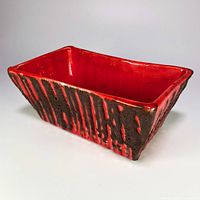 Angled view of rectangular red fat lava planter showing texture