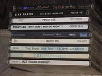 Stack of CD jewel cases showing spines with titles and catalog numbers
