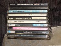 Stacked view of CD jewel case spines showing album titles and catalogue numbers