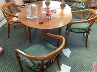 Overview of table with four armchairs around it; displays chair style and cushions
